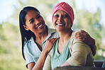 Happy, smile and woman with her mother with cancer sitting, bonding and spending time together. Sweet, love and portrait of sick mature female person embracing her adult daughter in an outdoor garden
