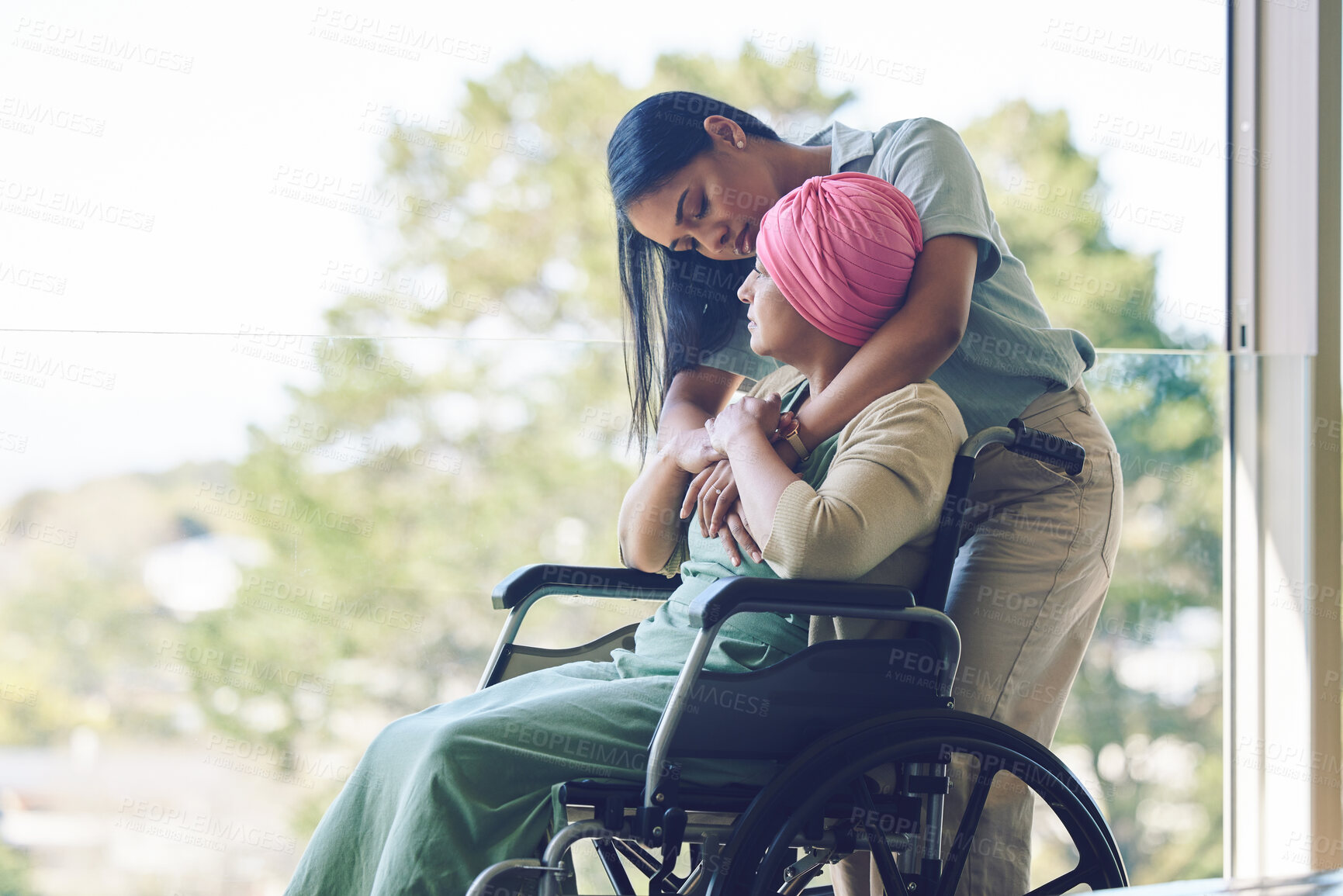 Buy stock photo Senior mother, woman and hug with wheelchair, love and care with bonding, kindness and nursing home. Girl, embrace and elderly person with disability for support, empathy or trust by window at clinic