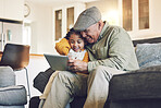 Girl kid, grandfather with tablet on sofa and relax together, watch cartoon or elearning games at home. Bonding, love and spending quality time, old man and female child with gadget and internet