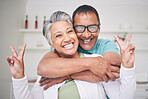 Peace sign, love and smile with portrait of old couple for support, happy and relax. Happiness, kindness and peace with senior man and woman hugging at home for embrace, trust and retirement