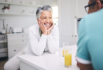 Buy stock photo Senior couple, love and conversation in kitchen with juice for quality time or happy in retirement. Smile, marriage and elderly woman or man with beverage in home for bonding on weekend or to relax.