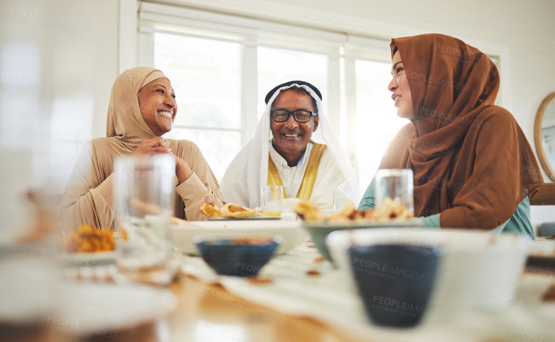Buy stock photo Food, conversation and muslim with big family at table for eid mubarak, Islamic celebration and lunch. Ramadan festival, culture and iftar with people eating at home for fasting, religion and holiday