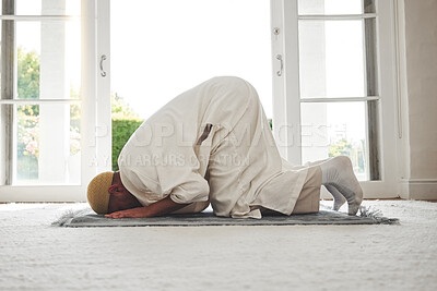 Buy stock photo Prayer, muslim and islamic with man on living room floor for eid mubarak, God and worship. Quran, hope and Ramadan with spiritual person praying on mat at home for faith, religion and gratitude