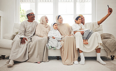 Buy stock photo Selfie, Islam and big family on sofa with smile, grandparents and parents with kids in Arab home. Portrait of Muslim men, women in hijab and happy children, generations in sitting on couch together.