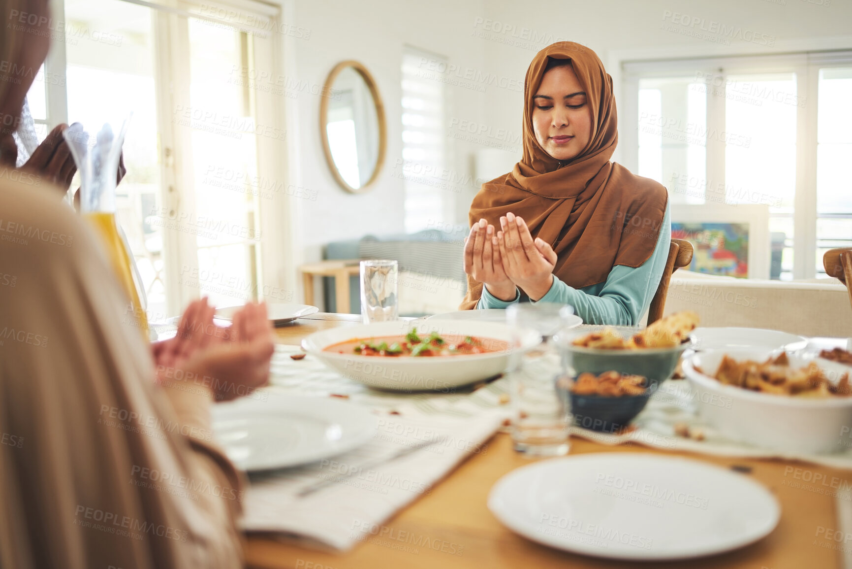 Buy stock photo Food, prayer and muslim with family at table for eid mubarak, Islamic celebration and lunch. Ramadan festival, culture and iftar with people praying at home for fasting, islam and religion holiday