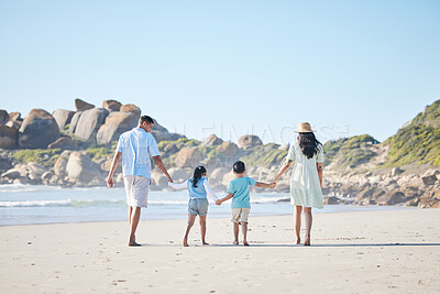 Buy stock photo Back, holding hands and a family at the beach for walking, bonding and on a vacation in summer. Care, nature and parents and children with affection while on a walk by the sea during a holiday