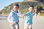 Children, brother and sister running at beach, portrait and holding hands with smile, adventure and holiday. Young kids, happy and playful with race, games and freedom by ocean for summer in Hawaii