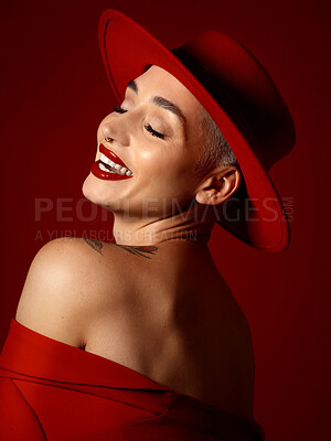 Buy stock photo Fashion, funny and a model woman on a red studio background for elegant or trendy style. Aesthetic, art and beauty with a young female person laughing in an edgy or classy unique clothes outfit