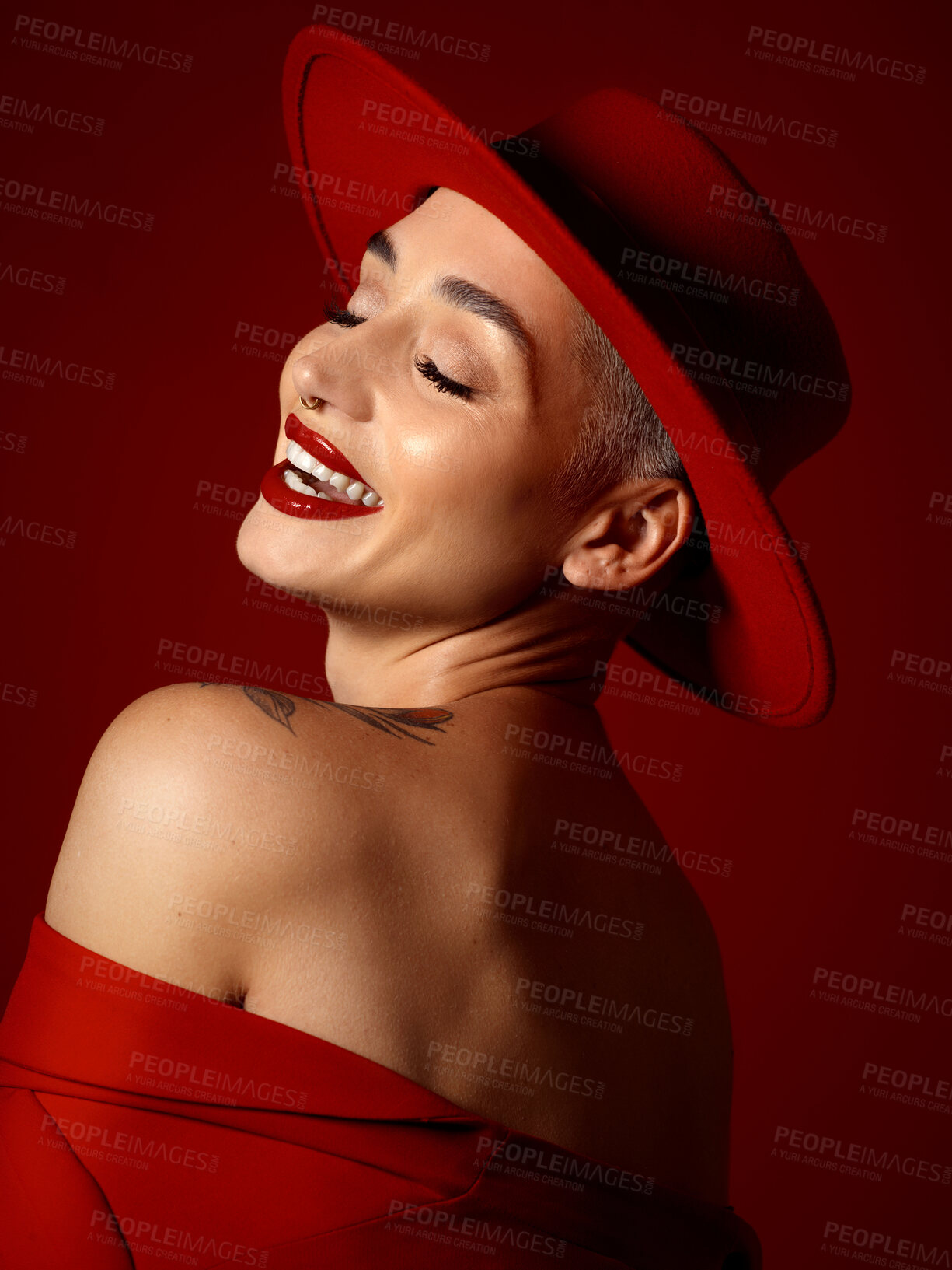 Buy stock photo Fashion, funny and a model woman on a red studio background for elegant or trendy style. Aesthetic, art and beauty with a young female person laughing in an edgy or classy unique clothes outfit