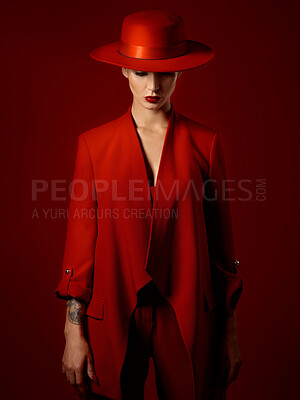 Buy stock photo Fashion, suit and hat on woman with beauty in studio with retro, style and edgy, confident or creative pose on red background mockup. Mystery character, model and girl with power or vintage aesthetic