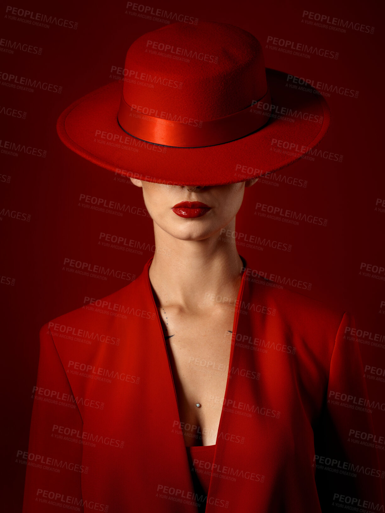 Buy stock photo Beauty, fashion and woman in a vintage suit with hat in studio with retro, style and edgy, confident or creative pose on red background. Mystery character, model and girl with power or aesthetic
