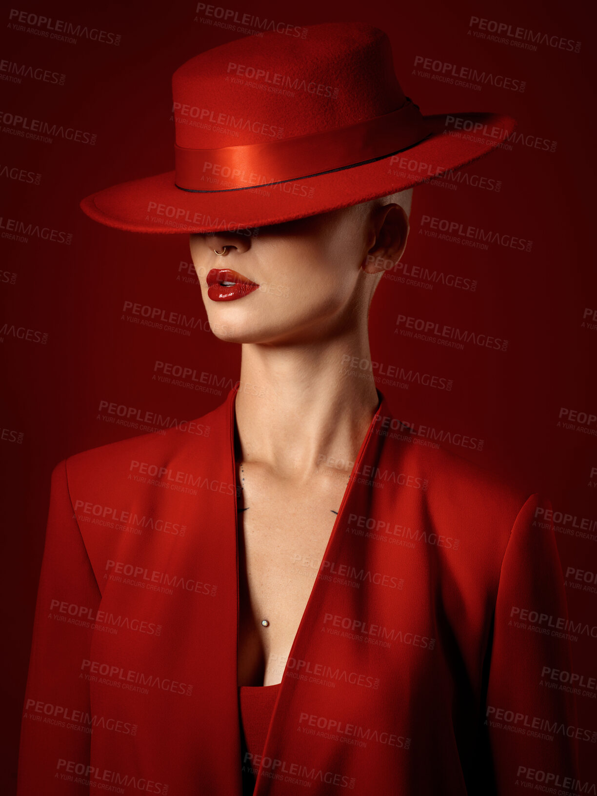 Buy stock photo Retro, fashion or woman in a vintage suit, hat and beauty in studio with creative, style and edgy or confident pose on red background. Mystery character, model and girl with power or aesthetic