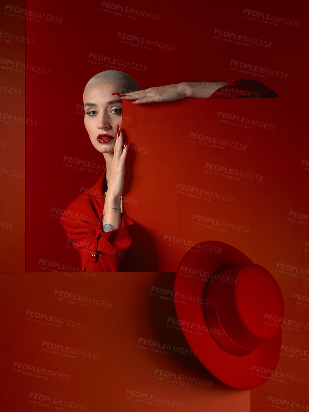 Buy stock photo Portrait, fashion and mock up with a woman on a red background in studio for marketing, advertising or branding. Luxury, aesthetic beauty or style with a trendy young model standing with empty space