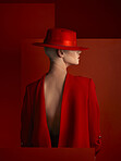 Back, fashion and space with a woman on a red background in studio for marketing, advertising or branding. Luxury, aesthetic style or a trendy young female model standing with empty or blank mockup
