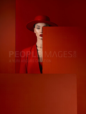 Buy stock photo Portrait, fashion and mock up with a woman on a red studio background for marketing, advertising or branding. Luxury, aesthetic style and hat with a young female model standing with empty space