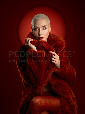 Buy stock photo Confident woman, fashion and portrait of a red coat in studio isolated on a background. Face, makeup and serious model with cosmetics, aesthetic and style in fur clothes from Switzerland by spotlight