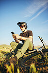 Mountain bike, phone and man outdoor in nature for extreme sports, training or workout. Smartphone, online communication and male person with bicycle for off road cycling, travel or adventure