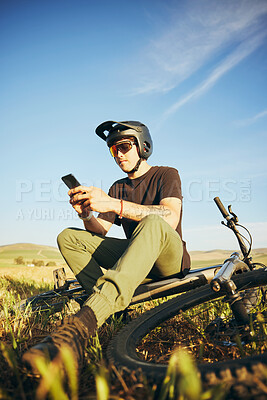 Buy stock photo Mountain bike, phone and man outdoor in nature for extreme sports, training or workout. Smartphone, online communication and male person with bicycle for off road cycling, travel or adventure