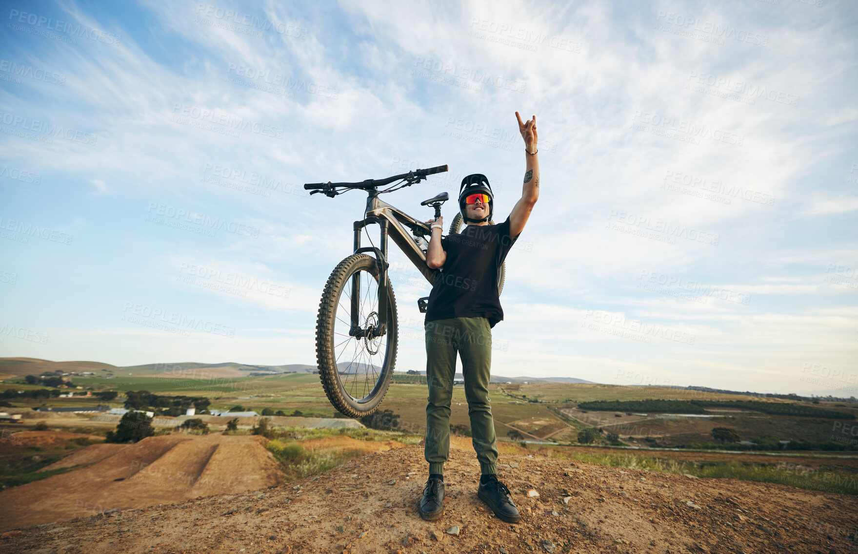 Buy stock photo Hand sign, mountain bike and man outdoor in nature for extreme sports, training or workout. Rock on, cool attitude and male person with bicycle for off road cycling, countryside travel or adventure