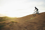 Mountain bike, downhill and man outdoor in nature for sports training or workout. Adrenaline, countryside and male athlete person with bicycle for off road cycling, travel or adventure on a hill