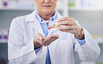 Pharmacist, hands and pills in pharmacy or closeup with medicine support or cure. Prescription, capsules and health care profession at drug store for treatment for correct dose or medical treatment.