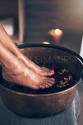 Buy stock photo Spa, health and woman feet in water to soak with flowers for a luxury, glamour and pedicure treatment. Wellness, beauty and closeup of female person relaxing for a zen self care routine at calm salon
