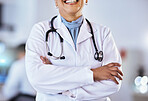 Doctor, arms crossed and stethoscope of a woman in a hospital for healthcare or cardiology. Closeup of a professional female medical worker ready for consultation, medicine and health check up
