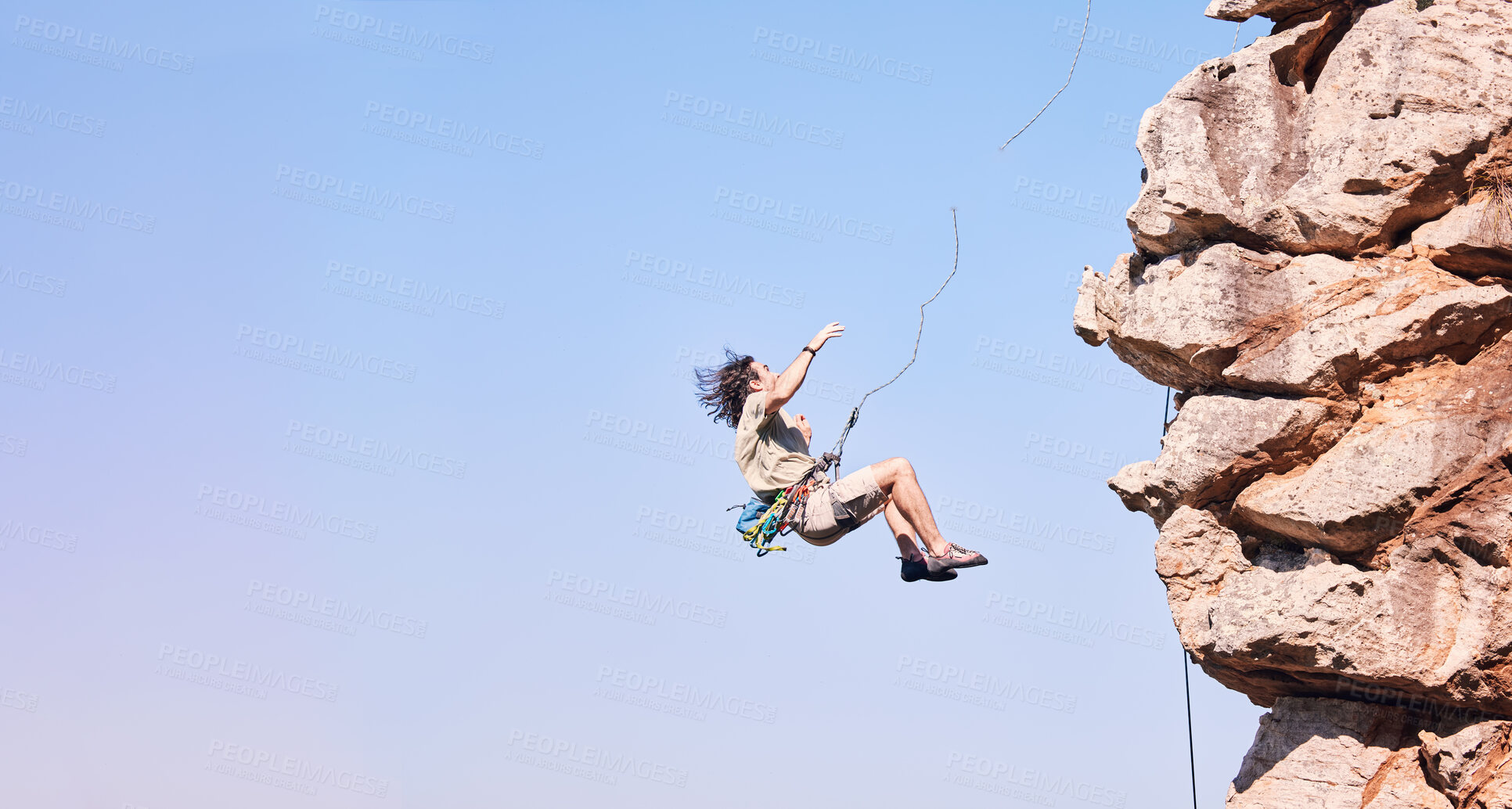 Buy stock photo Jump, rock climbing and space with man on mountain for fitness, adventure and challenge. Rope, workout and hiking with person training on cliff in nature for travel, freedom and exercise mockup