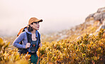 Mountains, hiking and woman thinking of nature journey, travel and outdoor adventure in bush or plants. Young person in South Africa search field or location for trekking and walking in backpack gear
