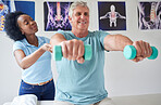 Physiotherapy, dumbbells and senior man with black woman for help with training or workout at clinic. Physical therapy, support and nurse with patient or equipment for rehabilitation in nursing home.