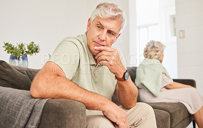 Buy stock photo Senior man, fight and thinking of divorce, breakup and stress of sad separation on sofa at home. Frustrated couple on couch in conflict, crisis and problem of drama, bad marriage or emotional anxiety
