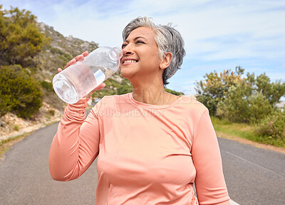Buy stock photo Senior woman, drinking water and bottle on road for fitness, running and thinking of goal, hydration or health. Mature lady, runner and detox with smile for wellness, exercise or workout in nature