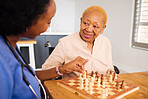 Nurse playing chess with a senior patient after a healthcare consultation in nursing rehabilitation center. Board game, conversation and female caregiver bonding with elderly woman in retirement home