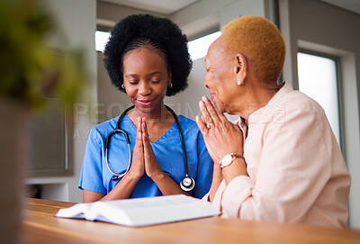 Buy stock photo Healthcare, black woman nurse and patient praying together while reading the bible in an old age home. Medical, trust or faith with a female medicine professional and senior adult talking to God