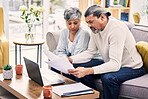 Documents, laptop and senior couple planning, finance paperwork and retirement funding or loan at home. Sofa, life insurance and asset management of elderly woman and partner with bills and computer