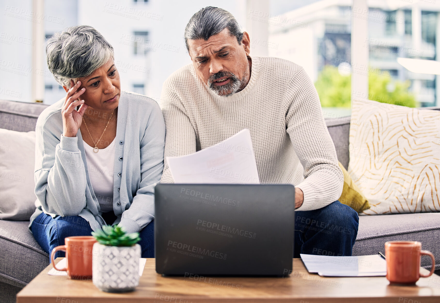 Buy stock photo Documents, stress and senior couple on computer with finance paperwork, taxes or retirement research at home. Planning, debt and elderly people on sofa reading insurance, bills and asset management