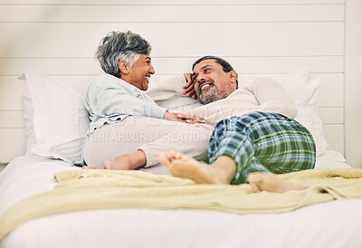 Buy stock photo Talking, happy or old couple in bedroom to relax, enjoy romance or morning together at home. Holding hands, senior woman or elderly man laughing or bonding with love, support or smile in retirement 