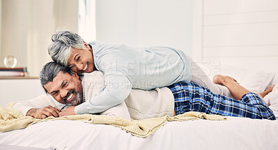 Buy stock photo Senior couple, funny and playful on bed in home, hotel and happy together for romance, game or comic joke. Elderly woman, old man and funny on vacation, holiday or relax in bedroom, wrestling or love