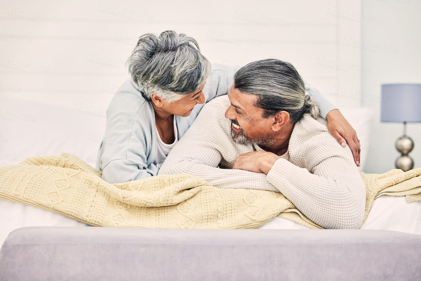 Buy stock photo Funny, playful or old couple in bedroom to relax, enjoy romance or morning time together at home. Hugging, silly senior woman or happy elderly man laughing or bonding with love or smile in retirement