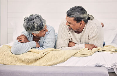 Buy stock photo Laughing, talking or old couple in bedroom to relax, enjoy conversation or morning together at home. Speaking, happy senior woman or funny elderly man bonding with love, joke or smile in retirement