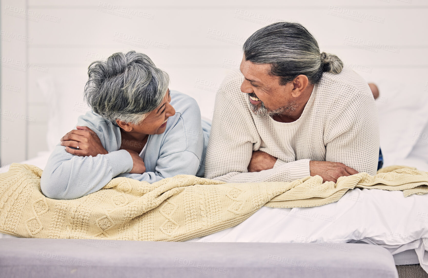 Buy stock photo Laughing, talking or old couple in bedroom to relax, enjoy conversation or morning together at home. Speaking, happy senior woman or funny elderly man bonding with love, joke or smile in retirement
