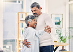 Happy senior couple, holding hands and dance in living room for love, care or bonding together at home. Elderly man and woman hug enjoying quality time, weekend or holiday celebration for anniversary