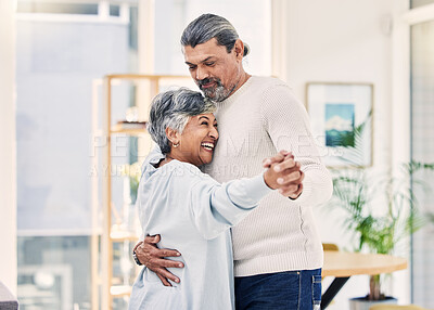 Buy stock photo Happy senior couple, holding hands and dance in living room for love, care or bonding together at home. Elderly man and woman hug enjoying quality time, retirement or celebration for anniversary