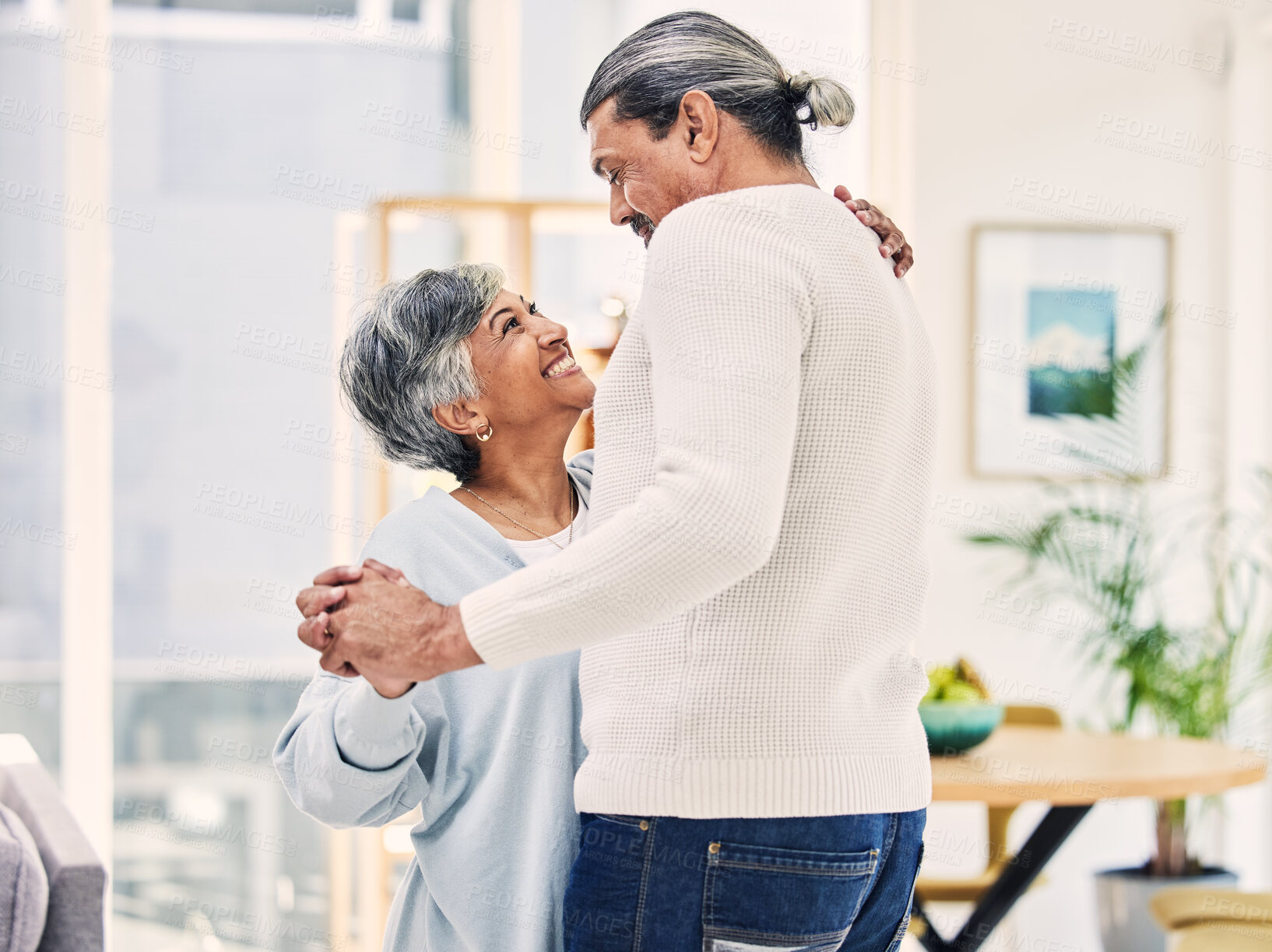 Buy stock photo Senior couple, hug and holding hands in dance for love, care or bonding together in living room at home. Elderly man and woman enjoying quality time, weekend or holiday celebration for anniversary