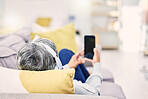 Relax, headphones and senior woman on a couch,  smartphone and internet connection with social media. Female person, mature lady or cellphone with headset, home or streaming music with audio or sound