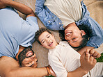 Happy family, above and relax at a park, bonding and enjoying the weekend outdoor. Top view, smile and boy child with parents on a field with freedom, love and vacation, care and chilling on lawn