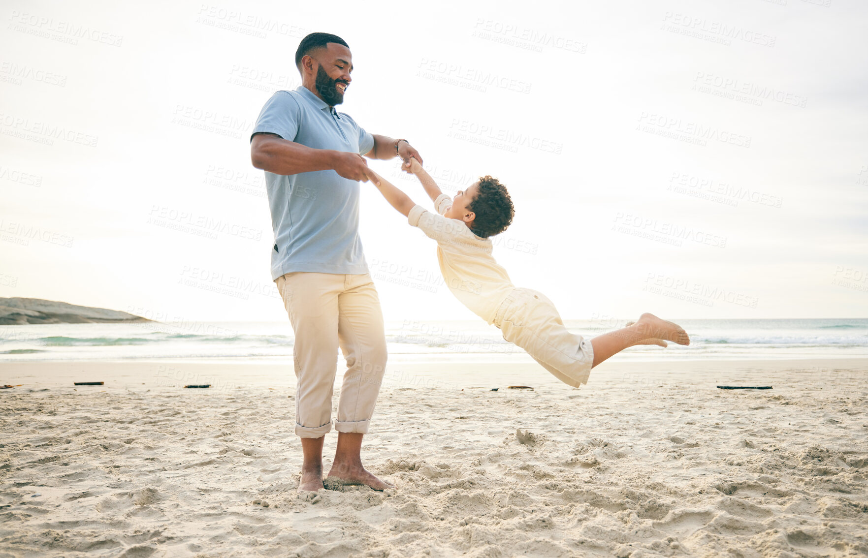 Buy stock photo Freedom, father and boy child at a beach with swing, fun and game while bonding in nature together. Love, ocean and parent playing with kid at the sea for travel holiday and vacation in Cancun 