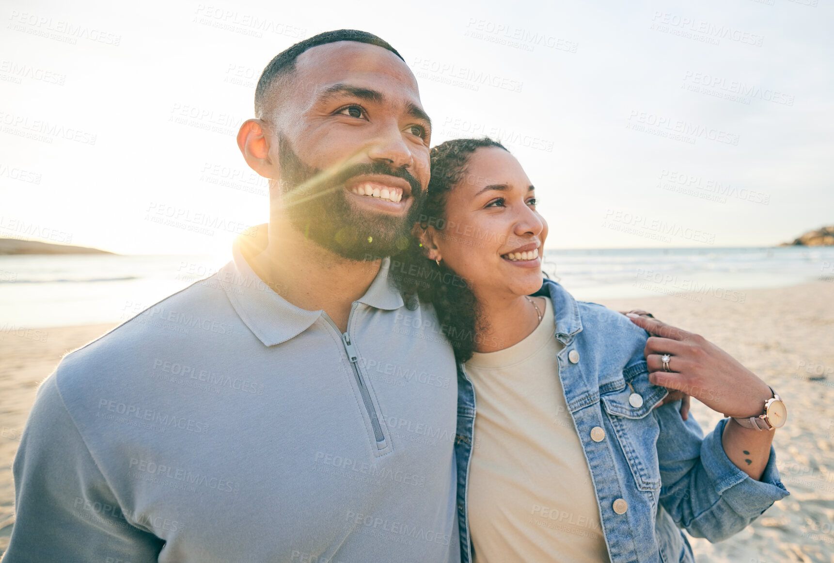 Buy stock photo Sunrise, happy and couple hug by beach for bonding, quality time and love on holiday in nature. Morning, relationship and face of happy man and woman embrace on vacation, honeymoon and travel by sea