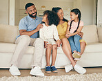 Parents, kids and relax on sofa of home for love, care and happy quality time together in living room. Mother, father and young children smile in support, trust and freedom of bonding in family house