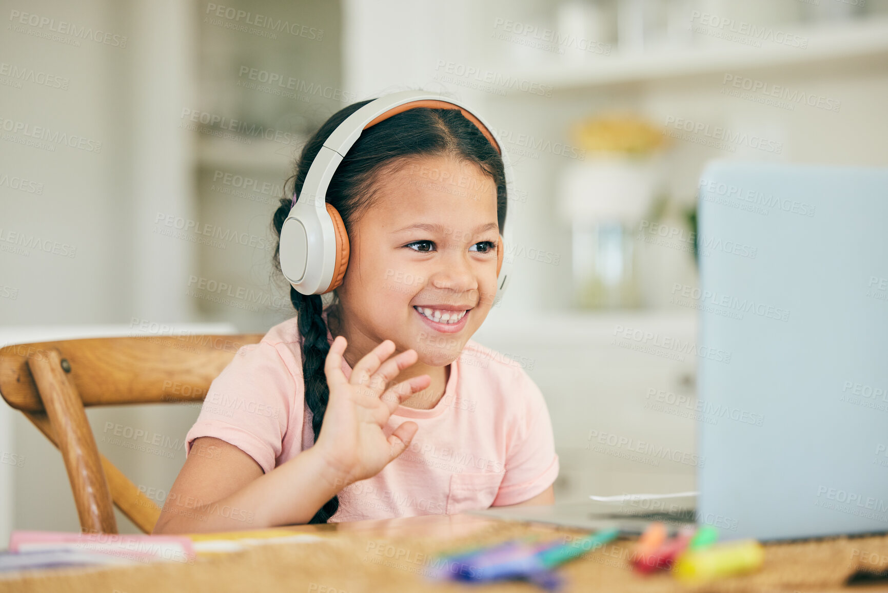 Buy stock photo Video call, laptop and child in headphones, audio technology and online class for home education or e learning. Virtual school, wave hello and girl student listening on computer on teaching platform